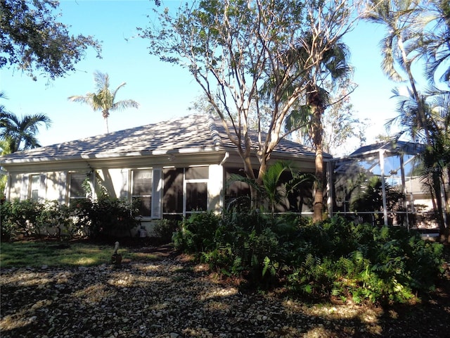1354 Tearose Pl, Sarasota, FL 34239 - rear view of property with a sunroom