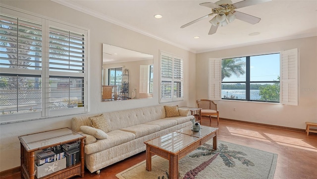 living room with ornamental molding, a wealth of natural light, and baseboards