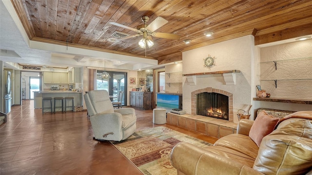 living room featuring a fireplace, visible vents, a textured wall, ornamental molding, and wooden ceiling