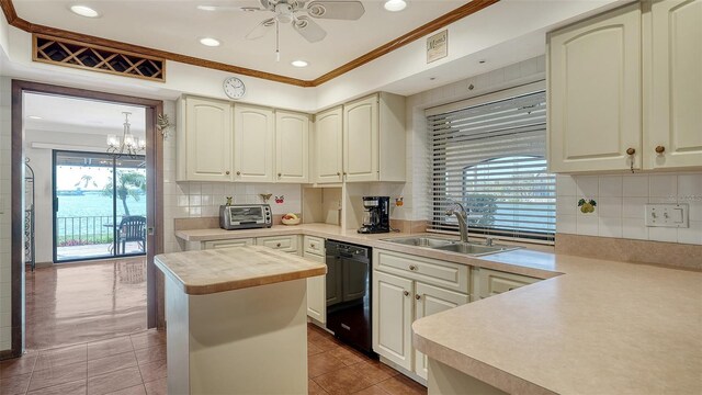 kitchen with a sink, black dishwasher, a toaster, and crown molding