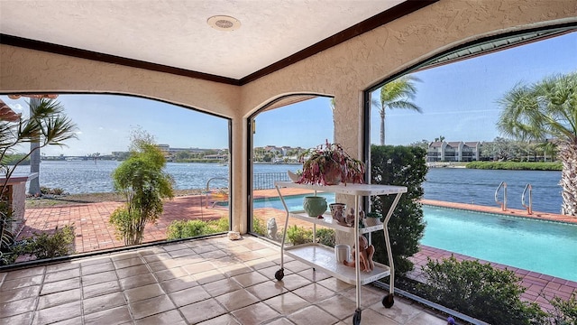 sunroom / solarium with a water view