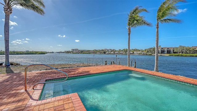 pool with a water view and a patio