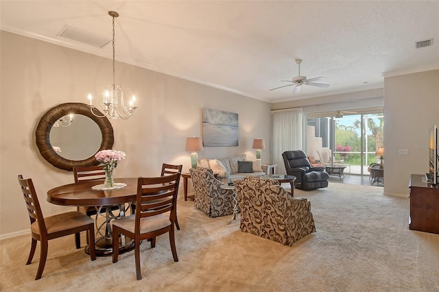 dining space with visible vents, crown molding, light carpet, and baseboards