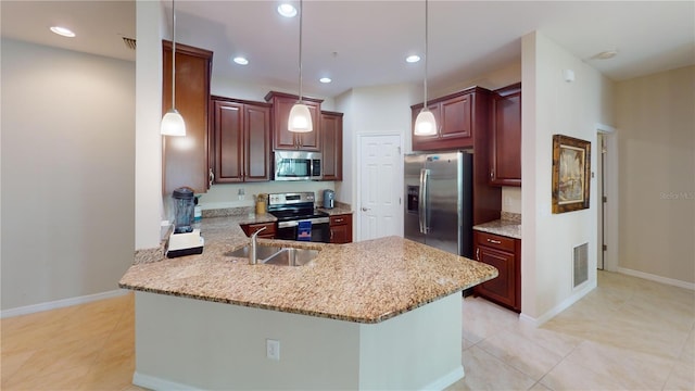 kitchen featuring pendant lighting, visible vents, appliances with stainless steel finishes, a sink, and a peninsula