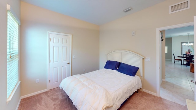 tiled bedroom featuring lofted ceiling, visible vents, and carpet flooring