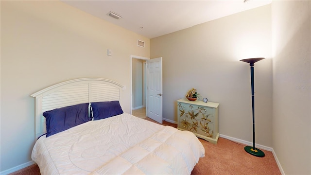 bedroom featuring carpet floors, visible vents, and baseboards