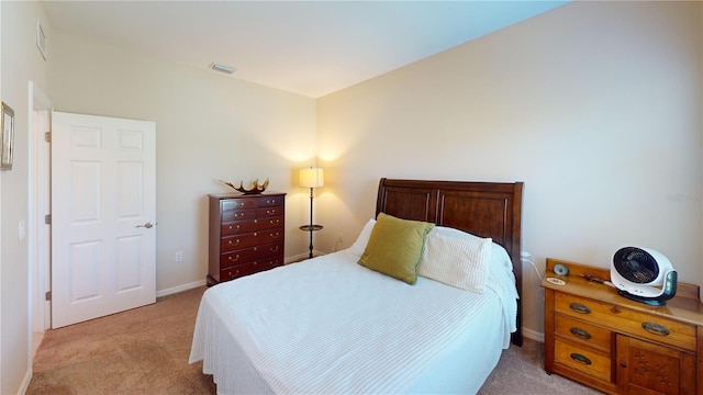 bedroom with light carpet, visible vents, and baseboards