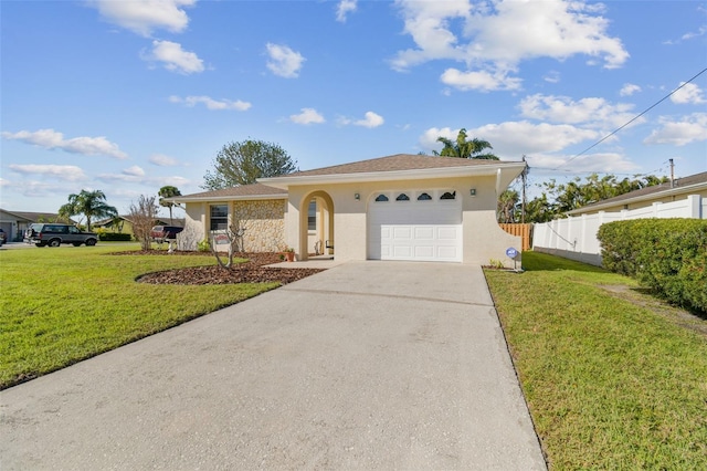 ranch-style house featuring a front yard, fence, an attached garage, and stucco siding