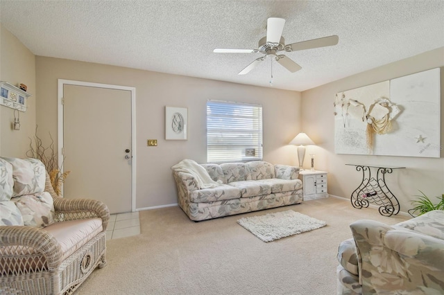 carpeted living area with a textured ceiling, a ceiling fan, and baseboards