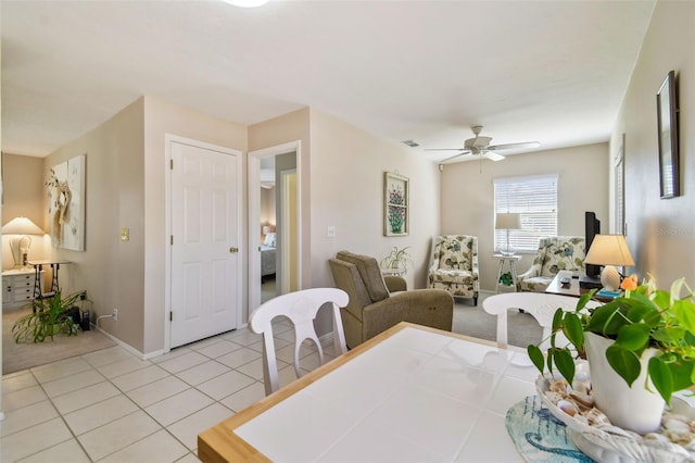 dining space featuring a ceiling fan, tile patterned flooring, visible vents, and baseboards