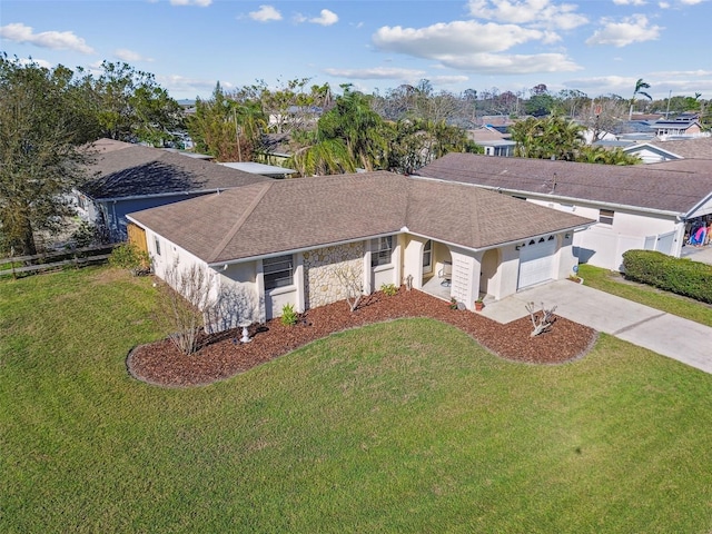 ranch-style house with stucco siding, concrete driveway, a front yard, fence, and a garage