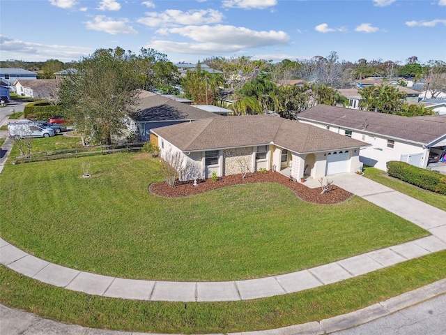 view of front facade featuring a garage, driveway, and a front lawn