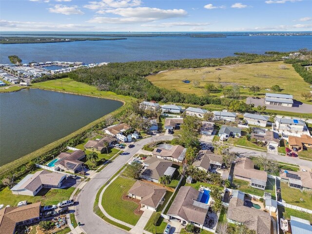 drone / aerial view with a water view and a residential view