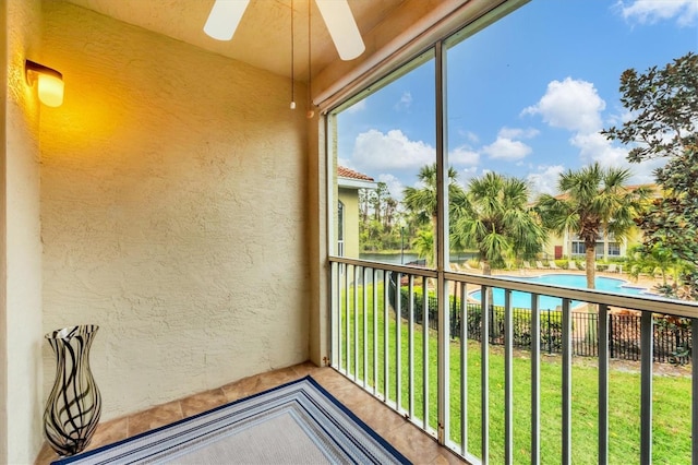 unfurnished sunroom with a ceiling fan