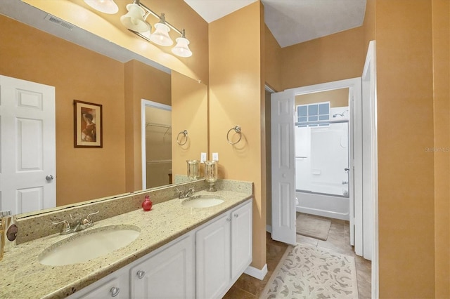 full bath featuring tile patterned flooring, double vanity, visible vents, and a sink