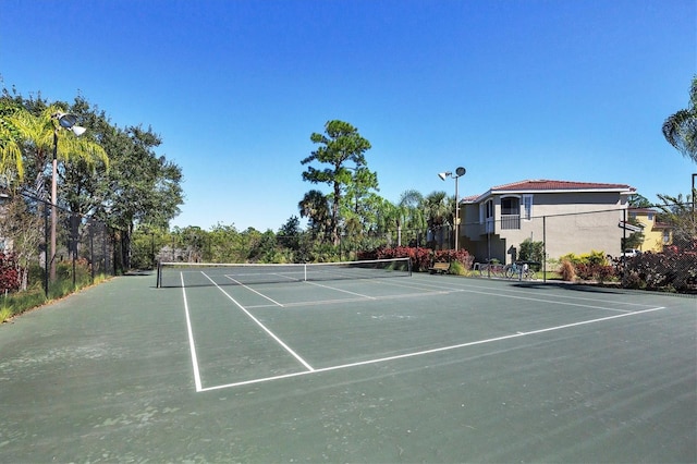 view of sport court featuring fence