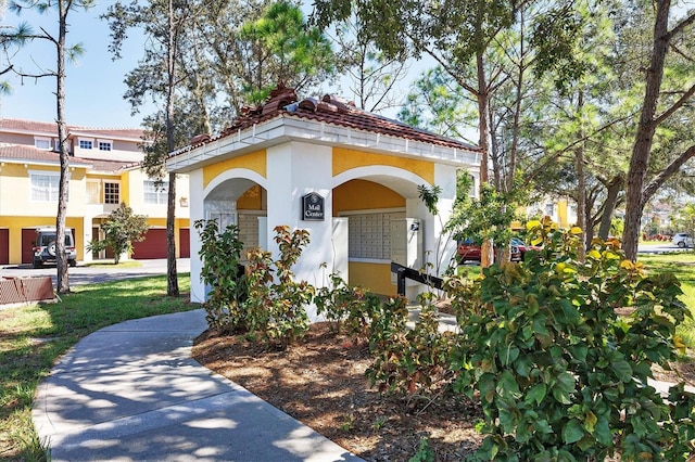 view of front of home featuring stucco siding and a tiled roof