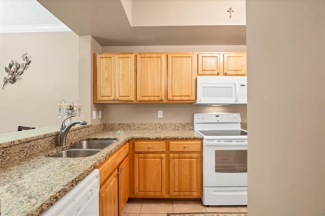 kitchen with light stone countertops, ornamental molding, light tile patterned flooring, white appliances, and a sink