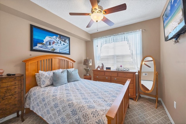 bedroom featuring light carpet, ceiling fan, a textured ceiling, and baseboards