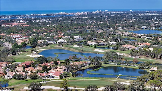 drone / aerial view with a residential view, a water view, and view of golf course