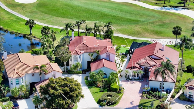 aerial view with a residential view, a water view, and view of golf course