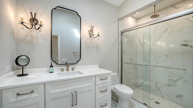 bathroom featuring vanity, toilet, marble finish floor, and a marble finish shower