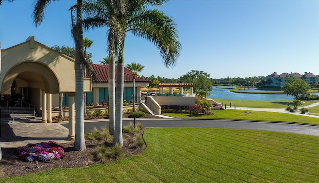 exterior space featuring a yard and a water view