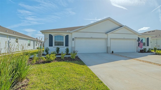 ranch-style house featuring an attached garage, a front yard, concrete driveway, and stucco siding