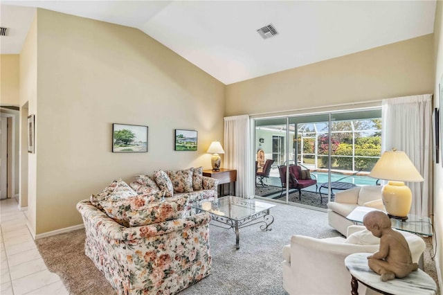 living area featuring tile patterned floors, baseboards, high vaulted ceiling, and a sunroom