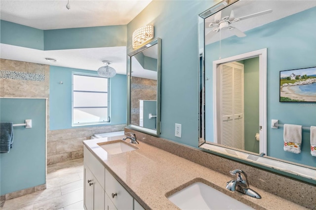 full bathroom with ceiling fan, tile walls, a walk in shower, and a sink