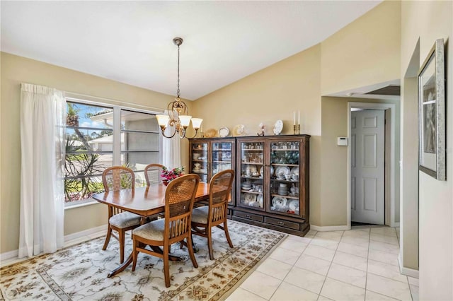 dining room with light tile patterned flooring, baseboards, and a chandelier