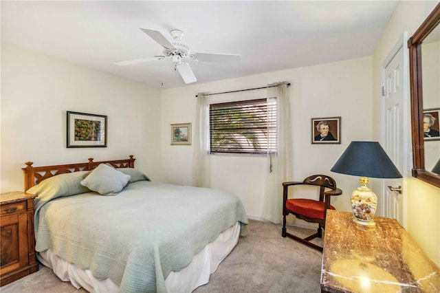 bedroom with light colored carpet and a ceiling fan