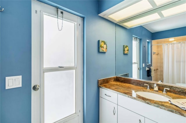 bathroom featuring curtained shower and vanity