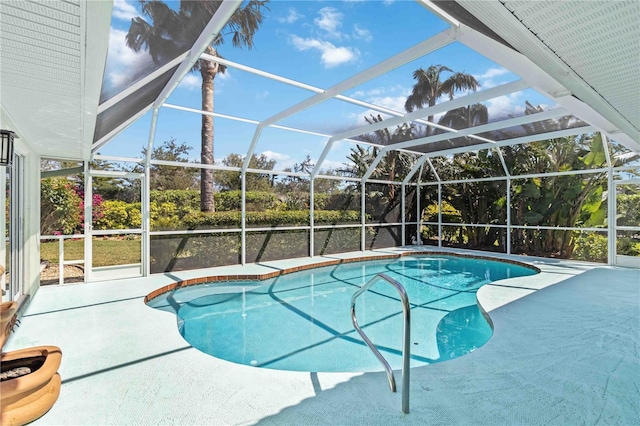 outdoor pool with a lanai and a patio area