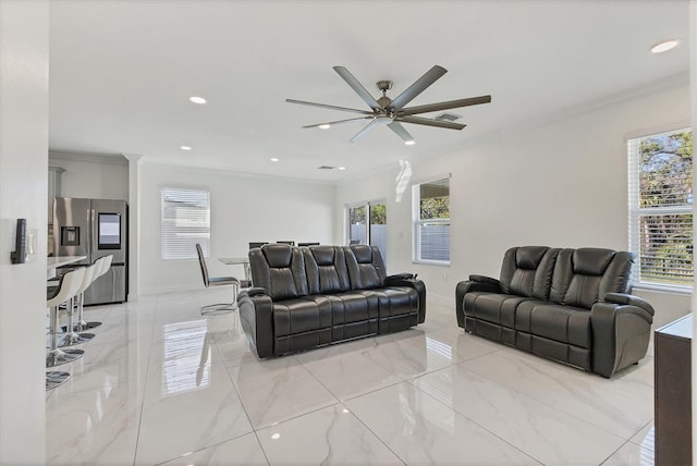 living room featuring marble finish floor, ceiling fan, and ornamental molding