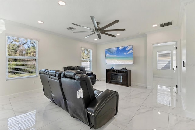 cinema featuring visible vents, marble finish floor, a ceiling fan, crown molding, and a healthy amount of sunlight