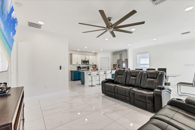 living room with visible vents, marble finish floor, a ceiling fan, and ornamental molding