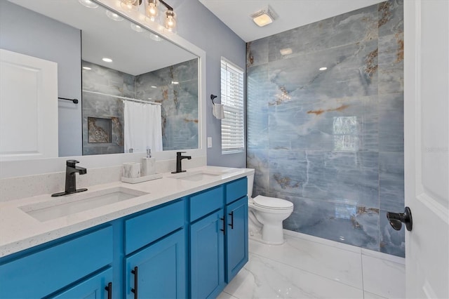 bathroom featuring toilet, a shower with curtain, marble finish floor, and a sink