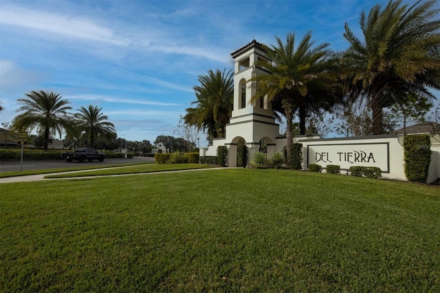 community sign featuring a lawn