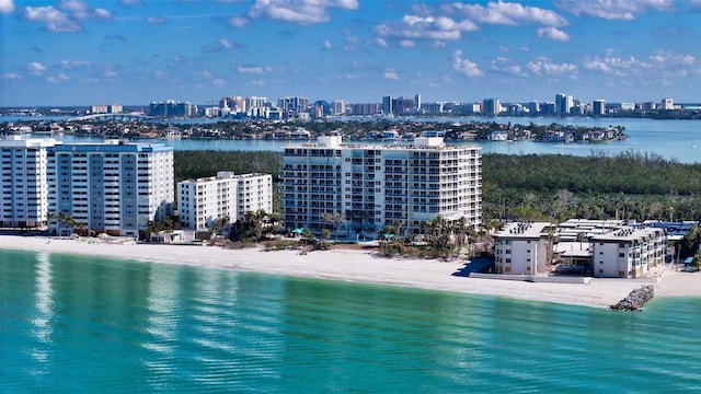 aerial view featuring a view of city, a beach view, and a water view