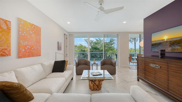 living area with marble finish floor, a wall of windows, a ceiling fan, and recessed lighting