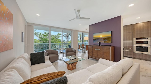 living room featuring marble finish floor, a wall of windows, a ceiling fan, and recessed lighting