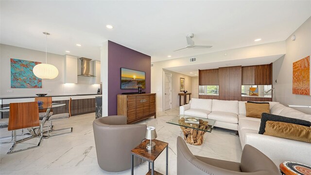 living area with marble finish floor, visible vents, a ceiling fan, and recessed lighting