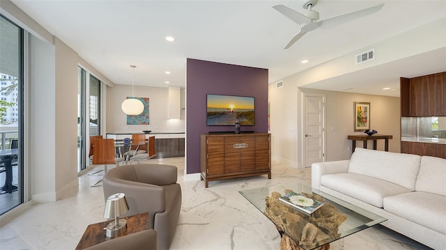 living room featuring marble finish floor, baseboards, visible vents, and recessed lighting