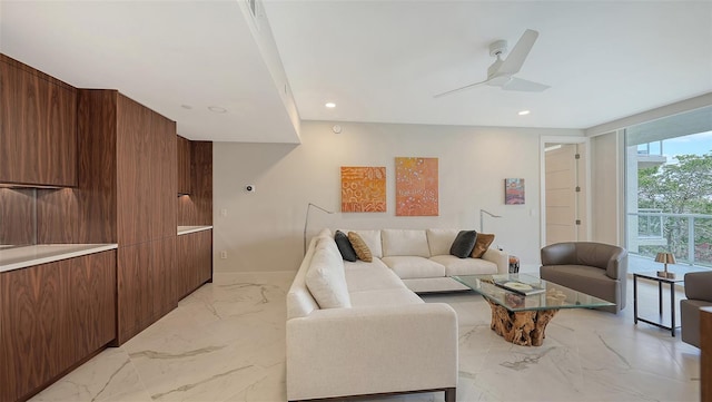 living area with marble finish floor, a ceiling fan, and recessed lighting