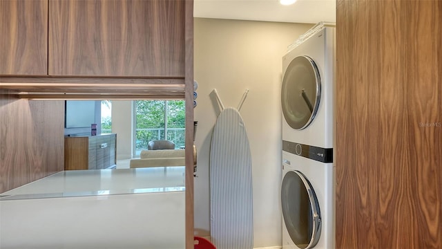 laundry room featuring laundry area and stacked washer and clothes dryer