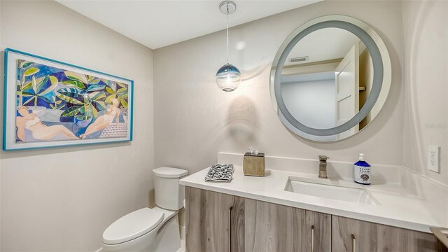 bathroom featuring toilet, visible vents, and vanity