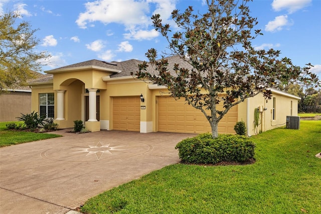 view of front of house with stucco siding, driveway, a front lawn, cooling unit, and a garage