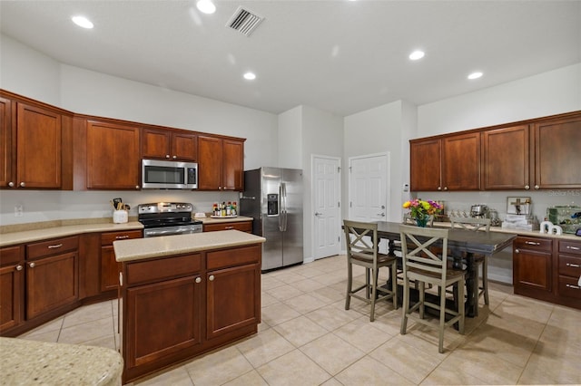 kitchen featuring visible vents, a kitchen island, appliances with stainless steel finishes, and recessed lighting