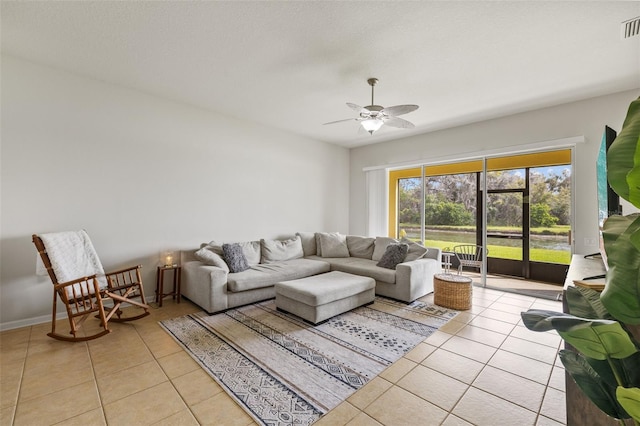 living area with baseboards, visible vents, a ceiling fan, and light tile patterned flooring